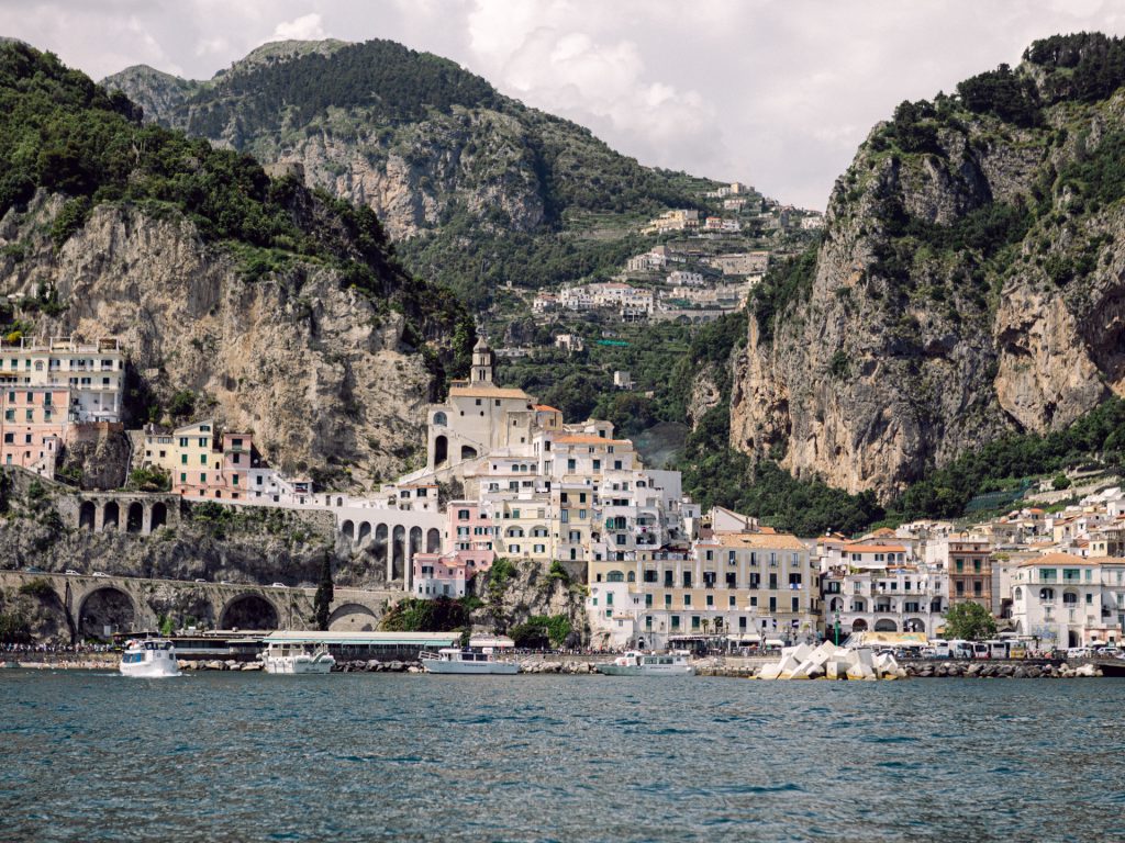 View of Amalfi from the sea, with the town rising up the cliffs above the harbour, Amalfi Coast