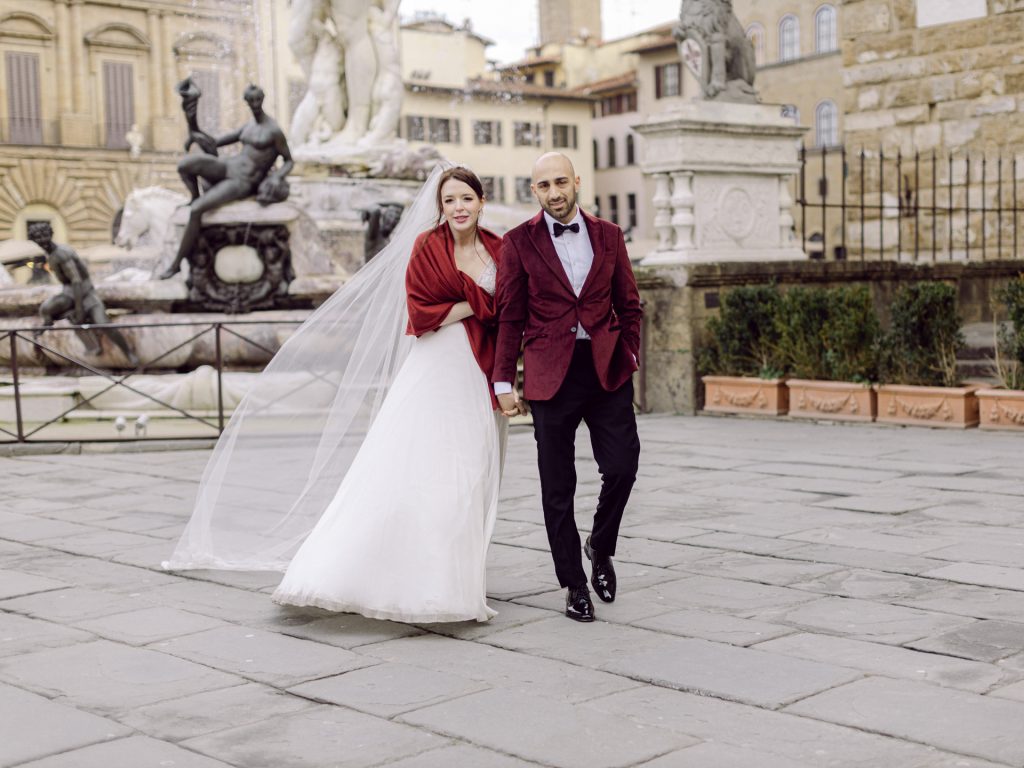 Couple walking through decorated Christmas streets in Florence city center