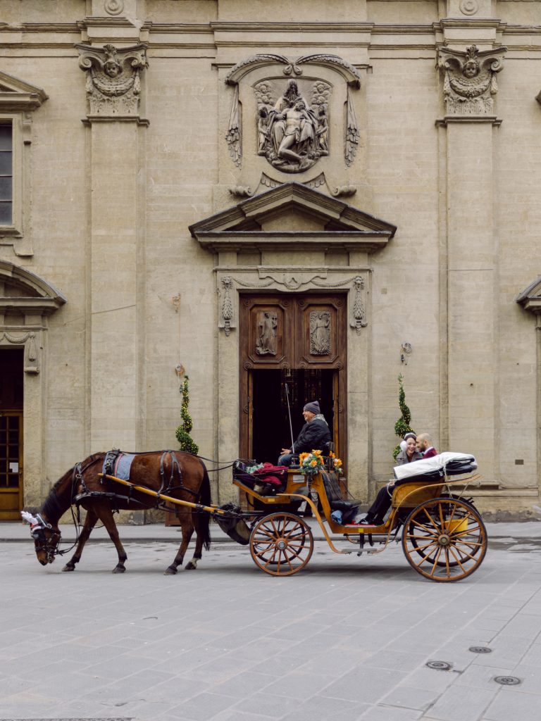 Romantic horse-drawn carriage ride during Christmas in Florence