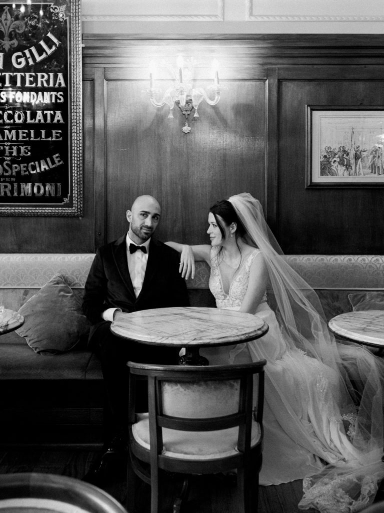 Couple enjoying coffee and pastries at Caffè Gilli during winter elopement