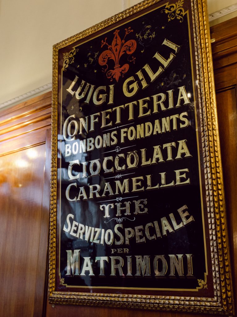 Couple enjoying coffee and pastries at Caffè Gilli during winter elopement