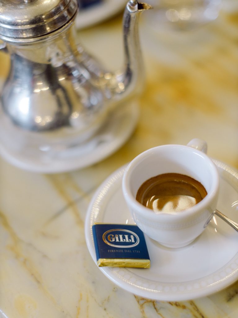 Couple enjoying coffee and pastries at Caffè Gilli during winter elopement