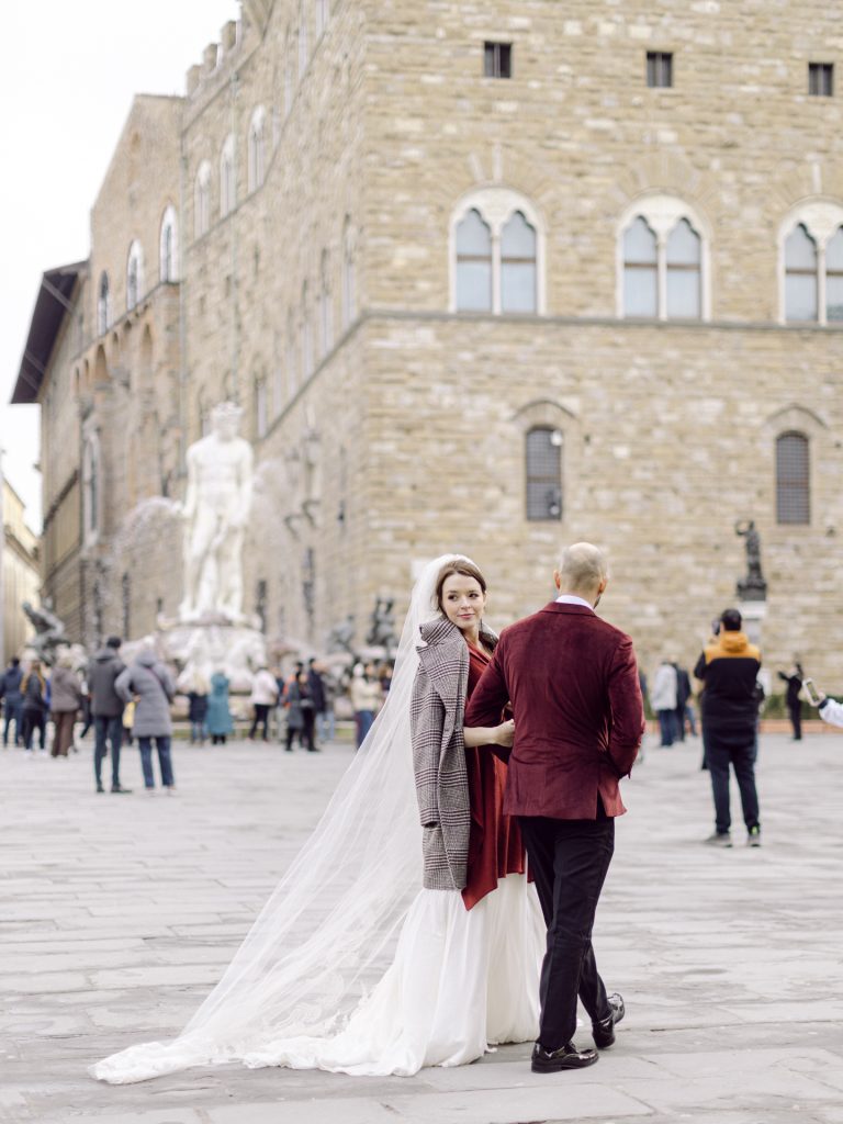 Couple walking through decorated Christmas streets in Florence city center