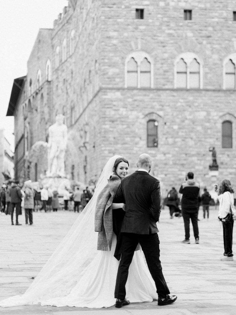 Couple walking through decorated Christmas streets in Florence city center