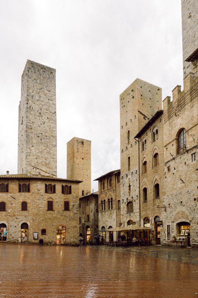 San Gimignano's empty piazza on a rainy day, Tuscany