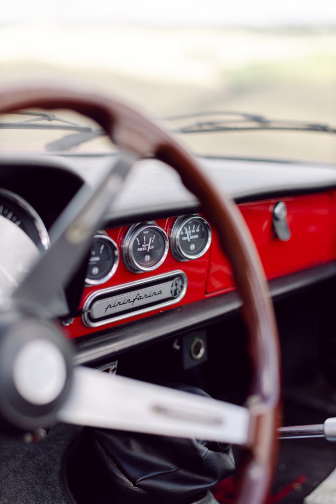 Old vintage car Alfa Romeo spider in red, detail of Pininfarina design