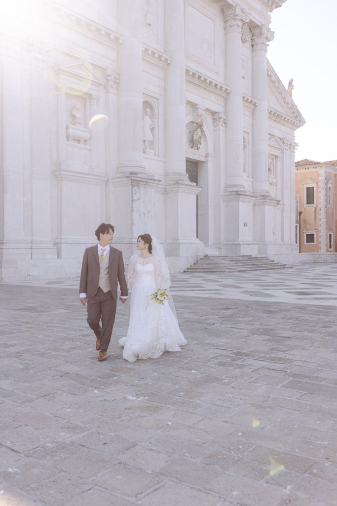 Walking Couple in wedding attire at San Giorgio Maggiore Church in Venice