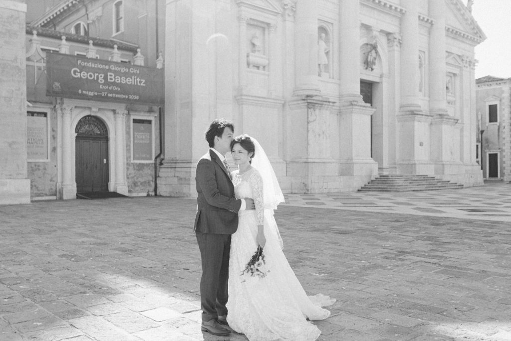 Couple in wedding attire at San Giorgio Maggiore Church in Venice