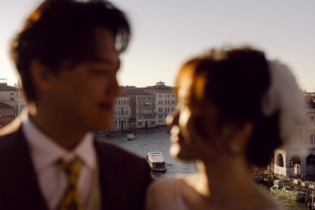 Couple on the terrace of Ca’ Sagredo overlooking the Grand Canal