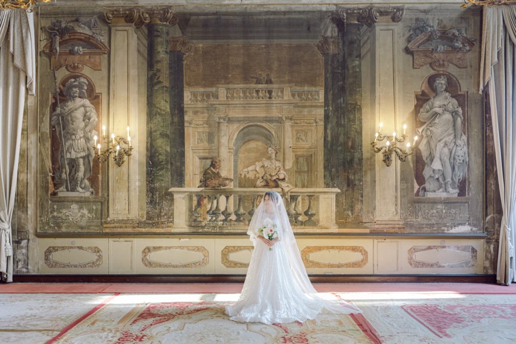 Bride in wedding attire posing for wedding portraits in Venice