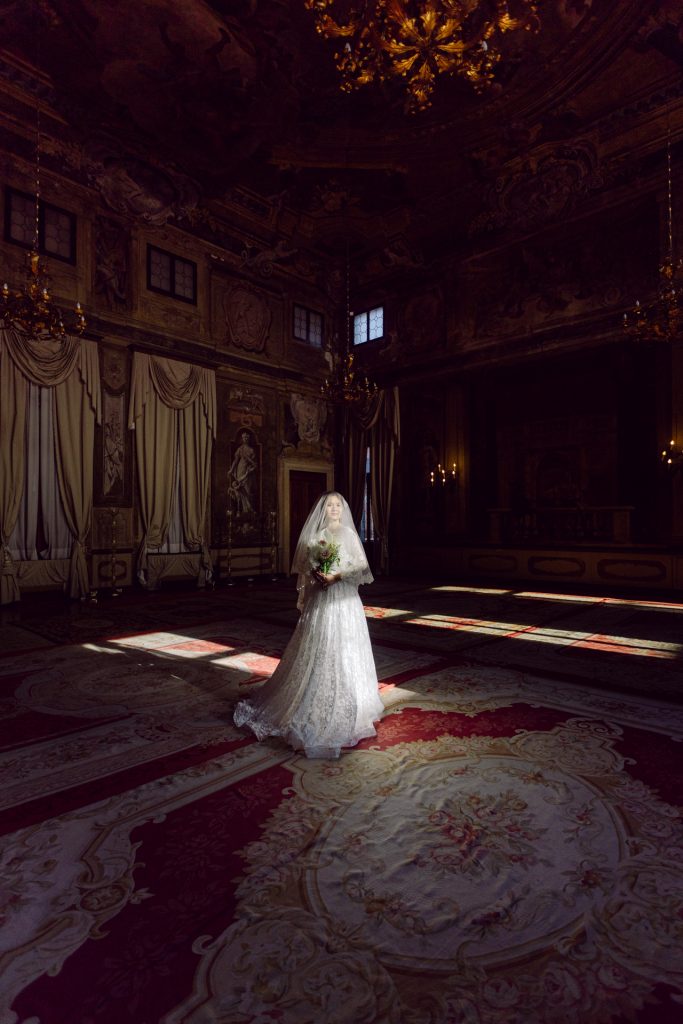 Bride in wedding attire posing for wedding portraits at Ca’ Sagredo, Venice