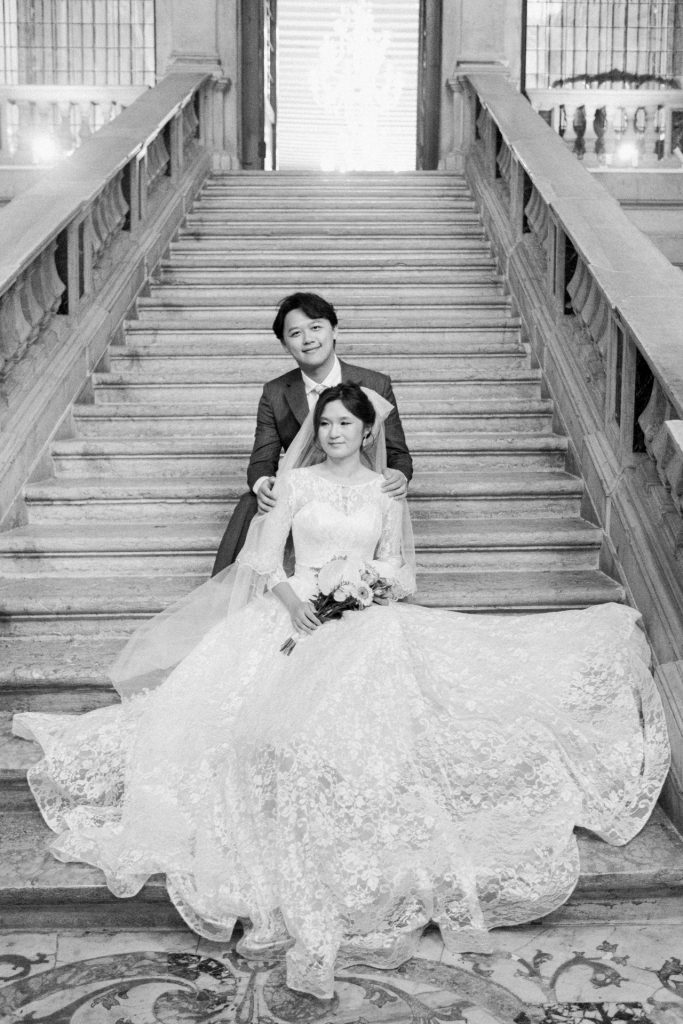 Sitting couple on Scalone dei Giganti at Ca' Sagredo in Venice monumental staircase built in the '700